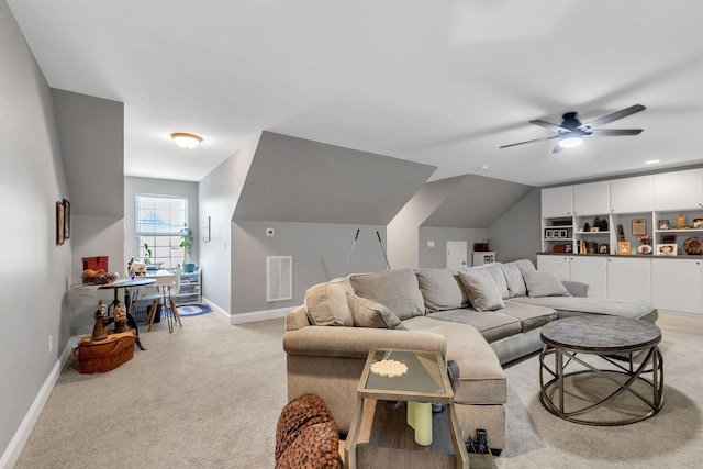 carpeted living room featuring ceiling fan and lofted ceiling