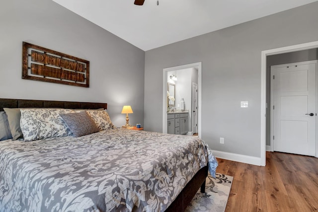 bedroom with hardwood / wood-style flooring, ensuite bath, and ceiling fan