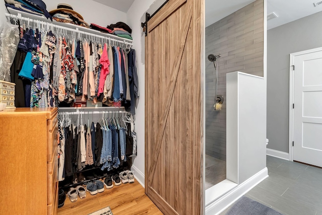 walk in closet with a barn door