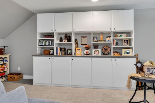 playroom featuring light colored carpet and lofted ceiling