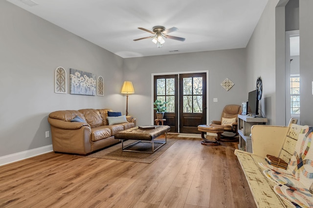 living room with ceiling fan and hardwood / wood-style floors