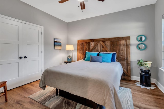 bedroom with a closet, ceiling fan, and light hardwood / wood-style flooring