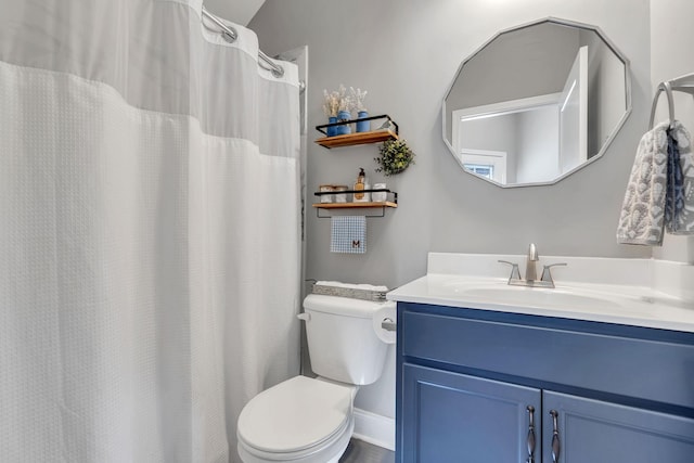 bathroom featuring vanity and toilet