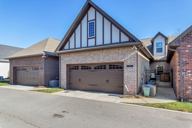 view of front of property featuring central AC and a garage