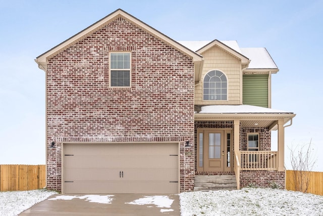 view of property with a porch and a garage