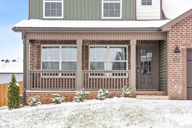 view of snow covered property entrance