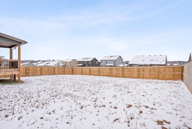 snowy yard featuring a deck