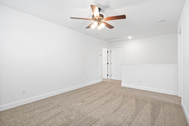 carpeted spare room featuring ceiling fan, baseboards, and recessed lighting