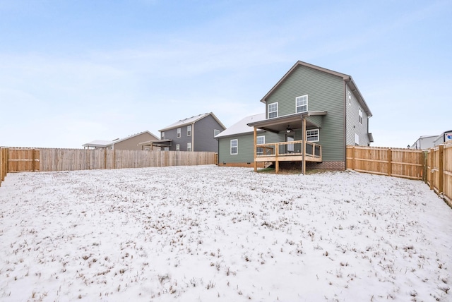 snow covered property with ceiling fan and a deck