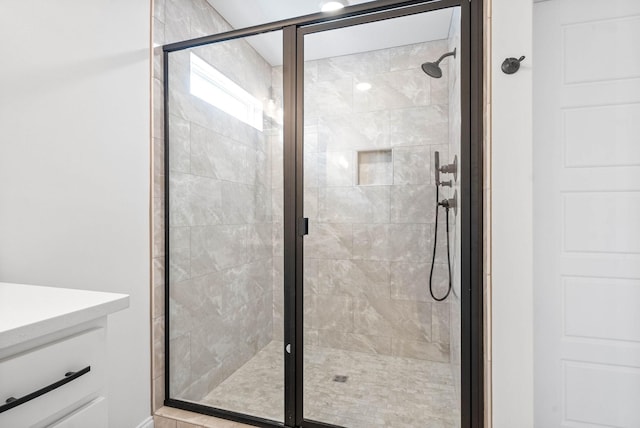 bathroom featuring a shower with door