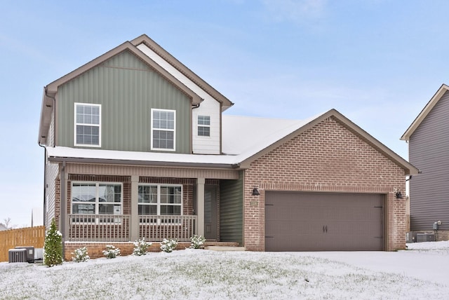 view of front property featuring a porch, a garage, and cooling unit