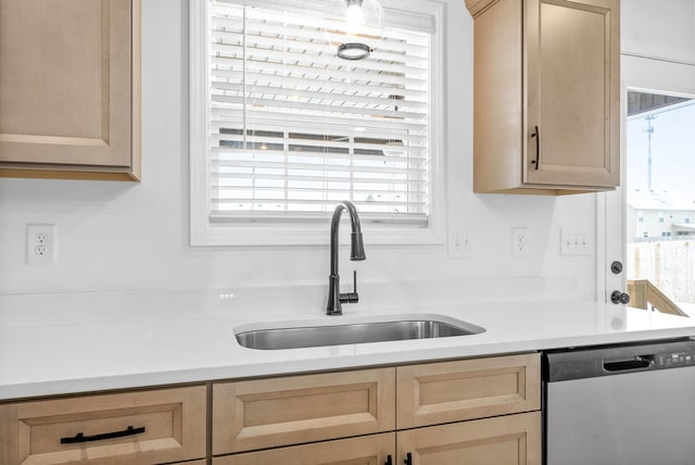 kitchen with sink, stainless steel dishwasher, and light brown cabinets