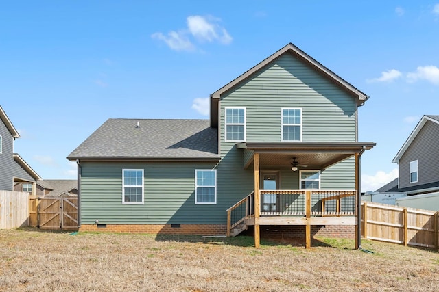 rear view of property with crawl space, a gate, fence, and a ceiling fan