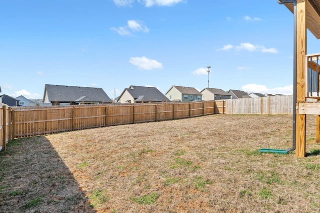 view of yard with a fenced backyard and a residential view