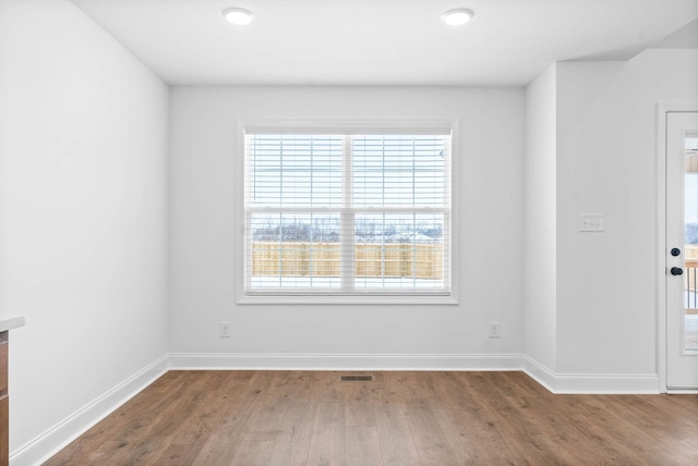 unfurnished room featuring hardwood / wood-style flooring