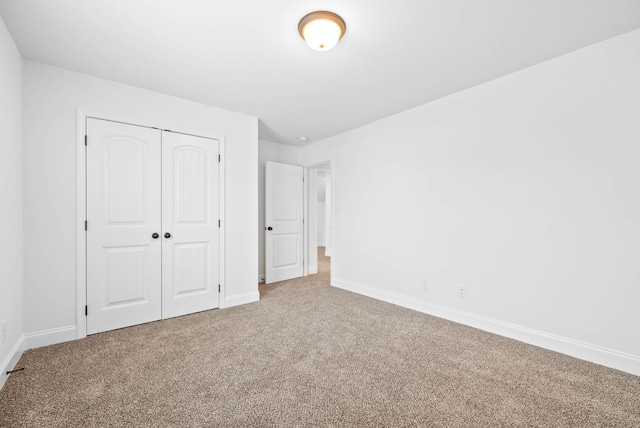 unfurnished bedroom featuring carpet floors and a closet