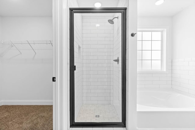 bathroom with separate shower and tub