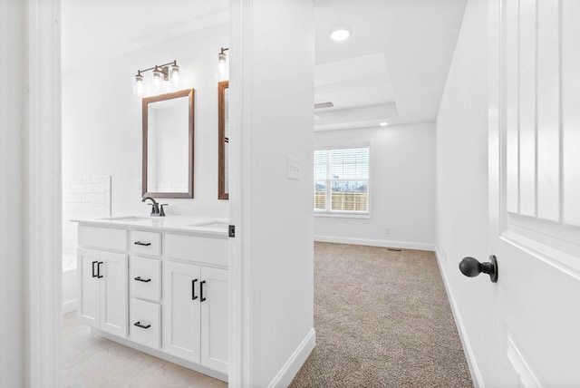 bathroom with vanity and a raised ceiling