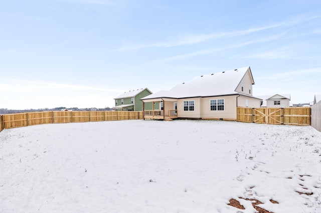 view of snow covered rear of property