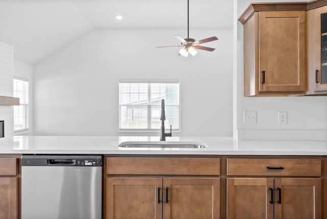 kitchen with a fireplace, ceiling fan, sink, dishwasher, and lofted ceiling