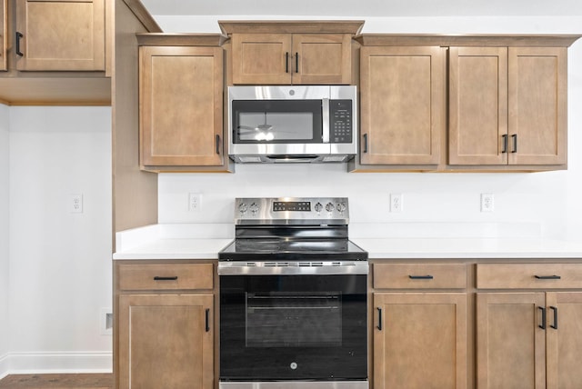 kitchen with ceiling fan and appliances with stainless steel finishes