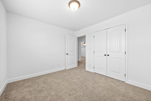 unfurnished bedroom featuring carpet flooring and a closet