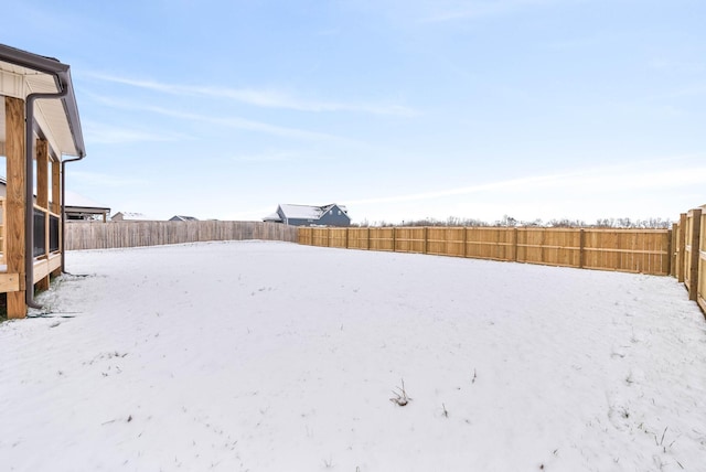 view of yard layered in snow