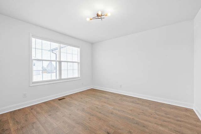 spare room with hardwood / wood-style floors