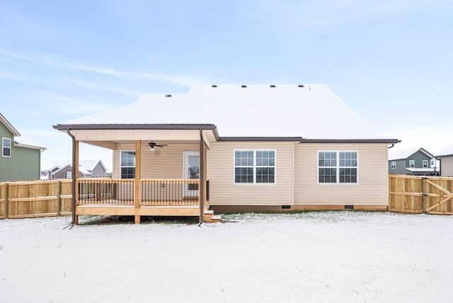 snow covered rear of property featuring a wooden deck and ceiling fan