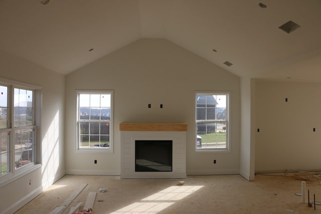 unfurnished living room featuring vaulted ceiling