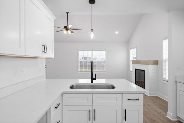 kitchen featuring light countertops, a sink, and a peninsula