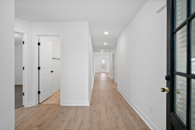 hallway featuring recessed lighting, light wood-type flooring, and baseboards