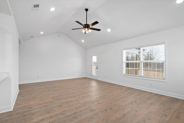 unfurnished living room featuring baseboards, visible vents, lofted ceiling, ceiling fan, and wood finished floors