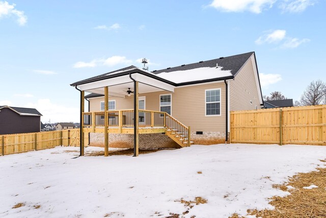 snow covered property featuring crawl space, fence private yard, and a ceiling fan