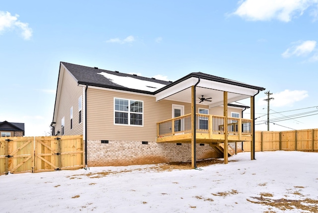 snow covered back of property featuring a ceiling fan, crawl space, fence private yard, a gate, and a deck