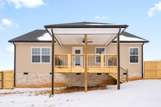 snow covered back of property with ceiling fan, crawl space, stairs, fence, and a wooden deck