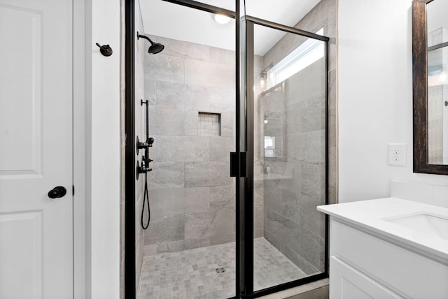 bathroom featuring a stall shower and vanity