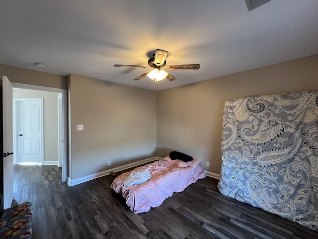 unfurnished bedroom featuring ceiling fan and dark hardwood / wood-style floors