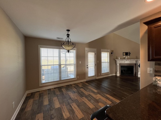 unfurnished living room featuring lofted ceiling and dark wood-type flooring