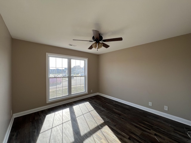 spare room with ceiling fan and dark hardwood / wood-style flooring