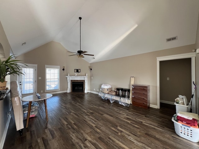 living room featuring ceiling fan, lofted ceiling, and dark wood-type flooring