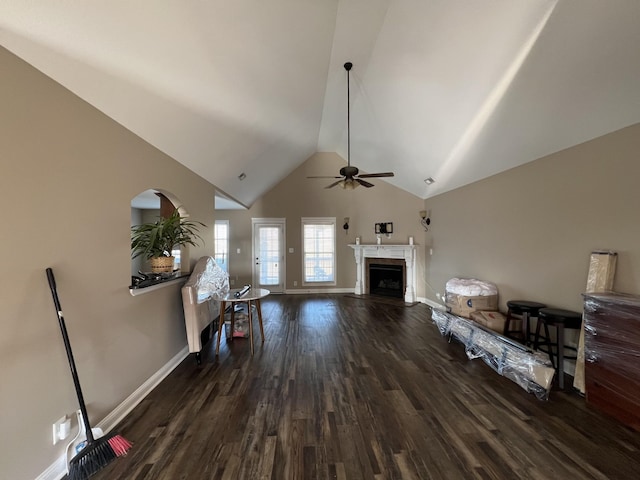 living room featuring high vaulted ceiling, ceiling fan, and dark wood-type flooring