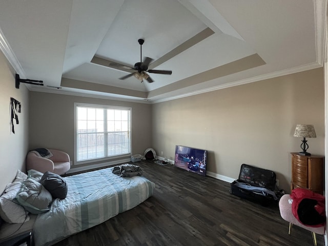 bedroom featuring dark hardwood / wood-style flooring, a raised ceiling, ceiling fan, and crown molding