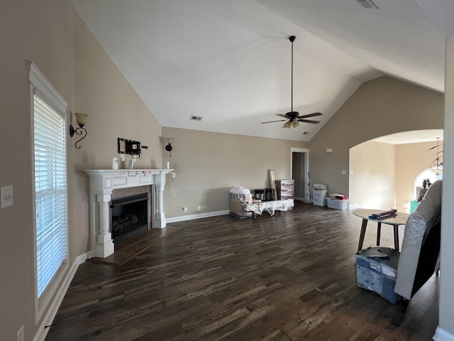 living room featuring ceiling fan, dark wood-type flooring, and vaulted ceiling