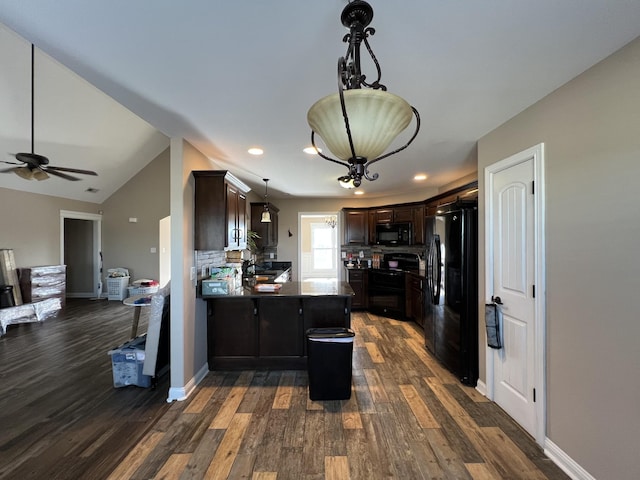 kitchen with dark brown cabinetry, hanging light fixtures, dark hardwood / wood-style floors, a kitchen island, and black appliances