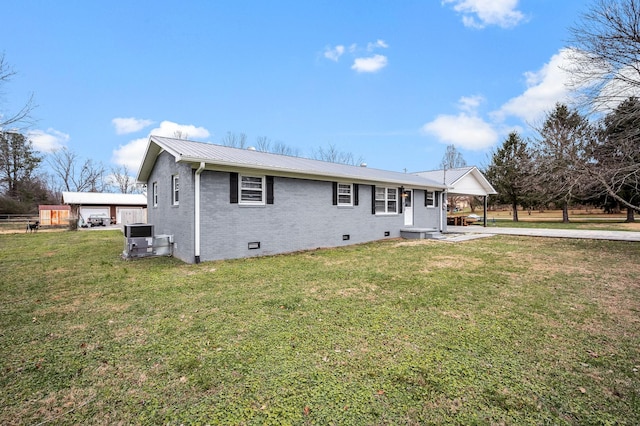 rear view of property with a yard