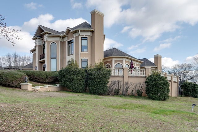 view of side of property with a yard