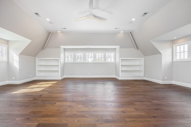 additional living space featuring built in shelves, lofted ceiling, and a wealth of natural light