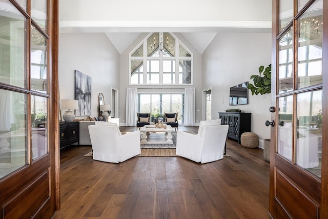 living room featuring french doors, high vaulted ceiling, dark hardwood / wood-style floors, and an inviting chandelier