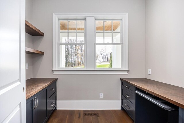 office space with dark wood-type flooring